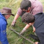 Three CEETEP participants examine a sediment core containing a tsunami sand layer from the banks of the Niawiakum River, WA.
