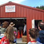 A field trip visit to a Makah Nation emergency supply depot to see how one community is working to provide for community needs in the event of a massive earthquake and tsunami. Workshop participants enter the garage-sized red building to see the supplies inside.