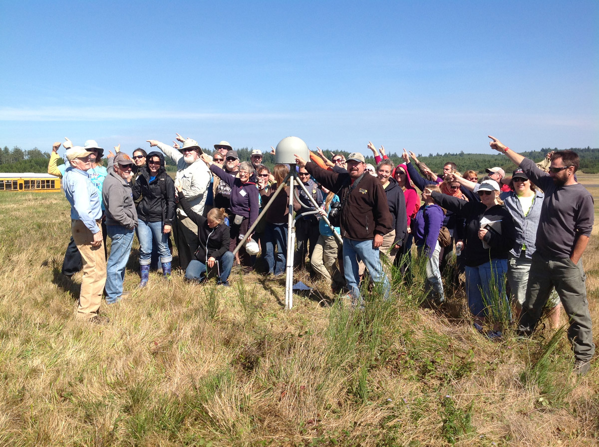 CEETEP participants from August 2013 workshop at GPS station P367 (Newport Oregon Airport) showing the direction of plate motion relative to stable North American (northeast)