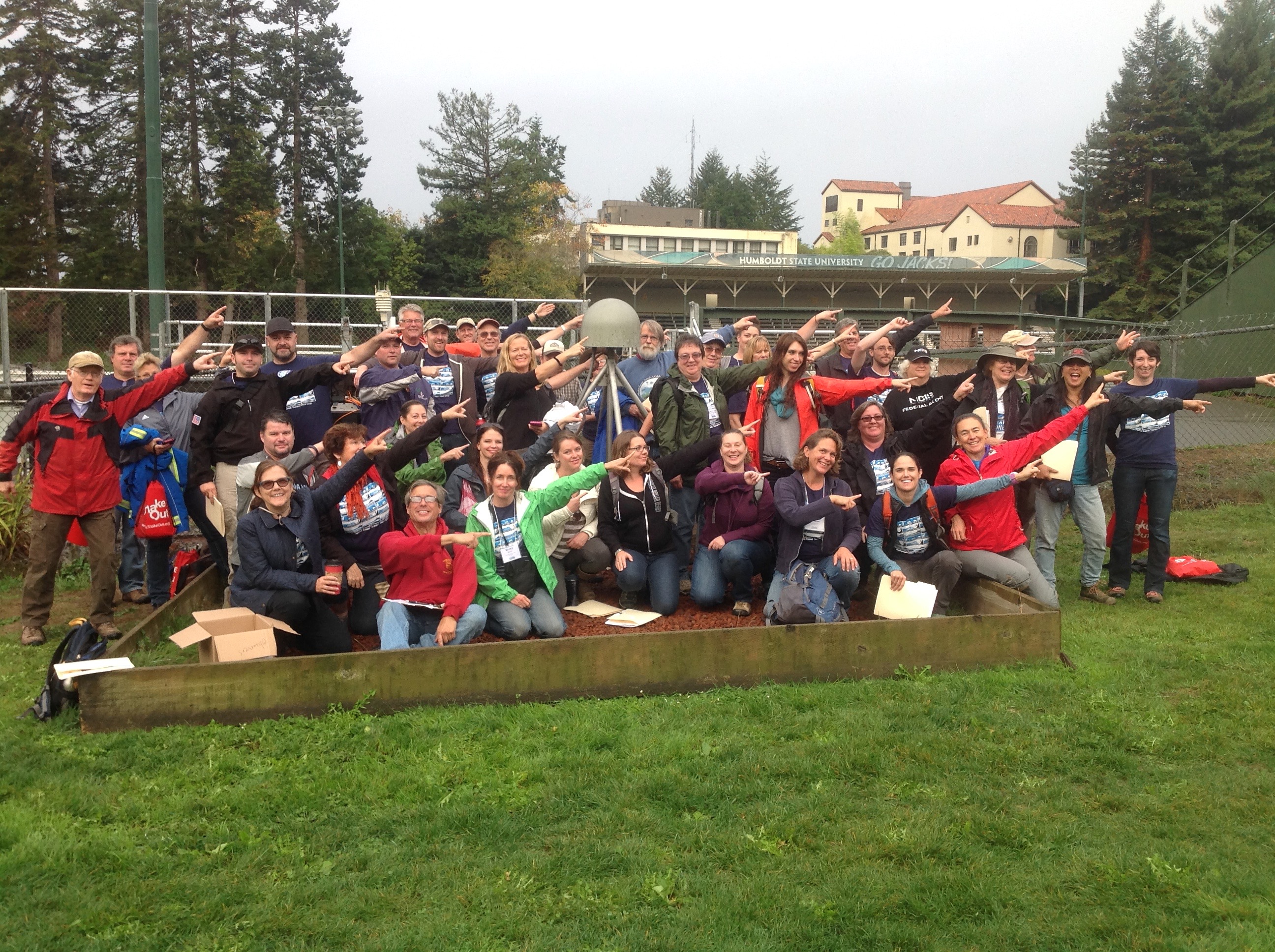 Workshop participants at the Humboldt State University GPS station, showing which way the plate is moving
